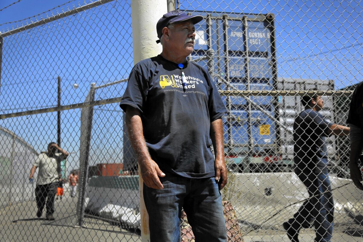 Alberto Arenas works at the Port of Los Angeles, where a group of warehouse workers has filed a class-action lawsuit seeking better wages.