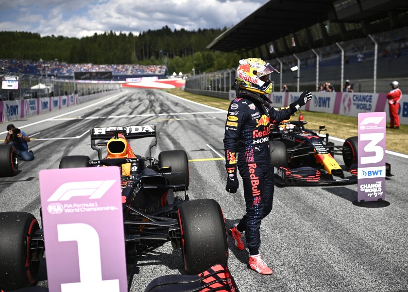 Red Bull driver Max Verstappen of the Netherlands waves in the winners circle after he placed first to take pole position during the qualifying session ahead of the Austrian Formula One Grand Prix at the Red Bull Ring racetrack in Spielberg, Austria, Saturday, July 3, 2021. The Austrian Grand Prix will be held on Sunday. (Christian Bruna/Pool Photo via AP)