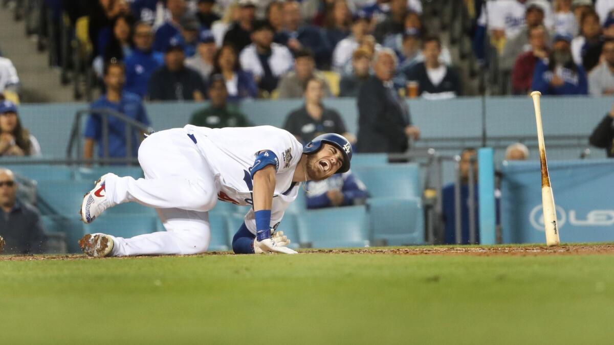 Dodgers right fielder Cody Bellinger goes down after taking a fastball to the knee during a 4-3 victory over the Cincinnati Reds on April 15.