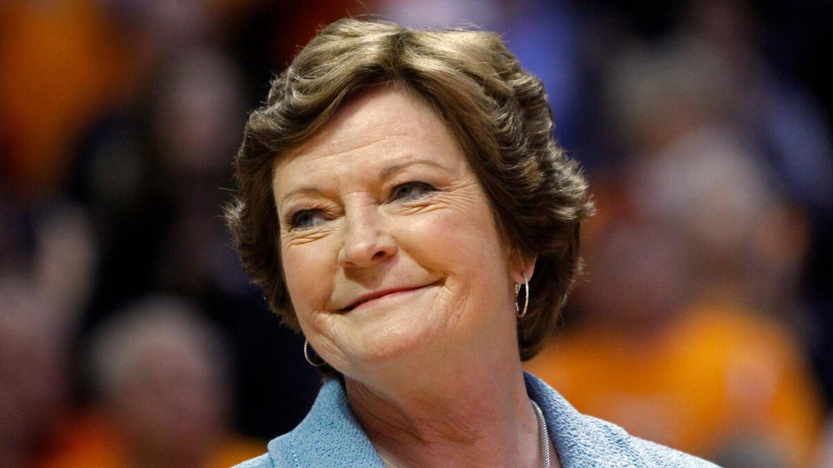 Former Tennessee women's basketball coach Pat Summitt smiles as a banner is raised in her honor before a 2013 game against Notre Dame in Knoxville, Tenn.