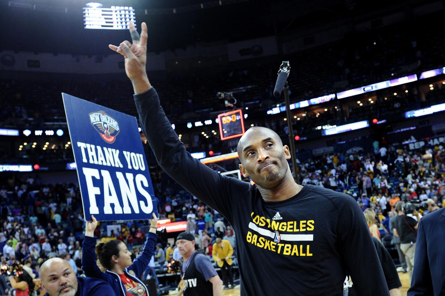 Kobe Bryant waves goodbye to fans as the Lakers leave the court following their loss to the Pelicans in the future Hall-of-Famers final game in New Orleans.