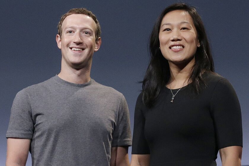 FILE- In this Sept. 20, 2016, file photo, Facebook CEO Mark Zuckerberg and his wife, Priscilla Chan, smile as they prepare for a speech in San Francisco. Liam Booth, the security chief of Zuckerberg and his family, has been accused of sexual misconduct and making racist and homophobic comments about members of his staff and about Zuckerbergs wife, Chan. (AP Photo/Jeff Chiu, File)