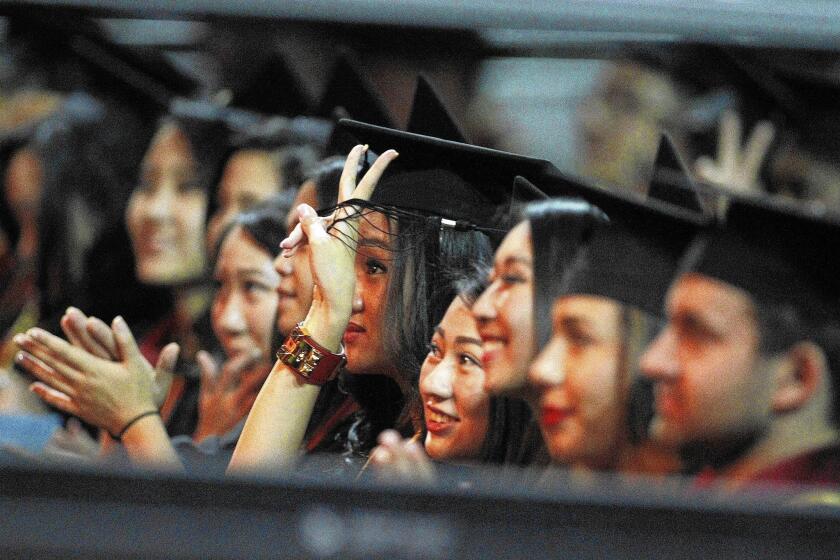 A college graduate needs to establish a good credit rating. Above, USC Marshall School of Business graduates cheer after listening to commencement addresses.