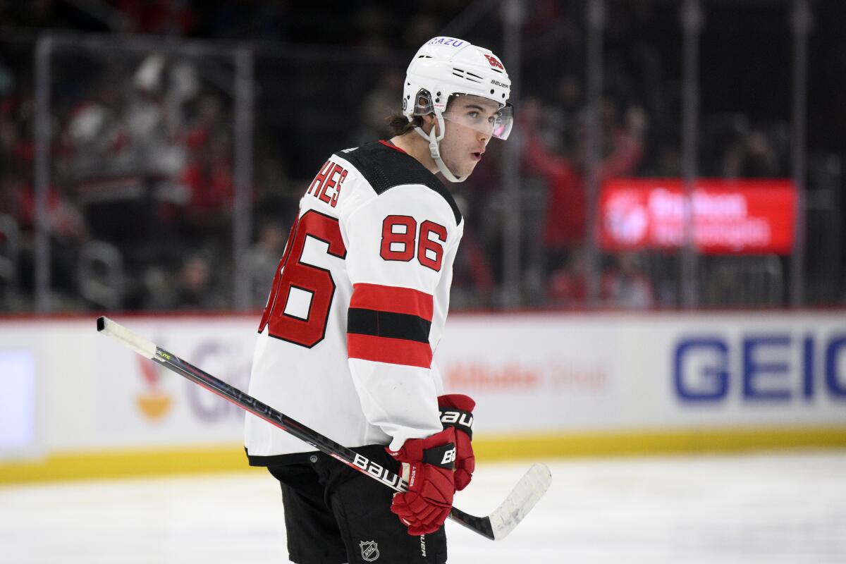 New Jersey Devils center Jack Hughes reacts after he scored a goal during the second period of an NHL hockey game against the Washington Capitals, Saturday, March 26, 2022, in Washington. (AP Photo/Nick Wass)
