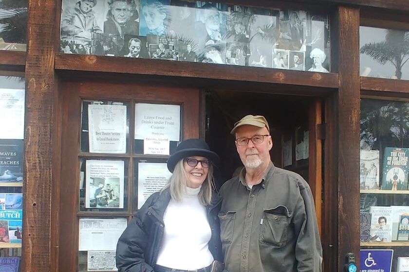 Actress Diane Keaton takes a break from browsing at D.G. Wills Books in La Jolla on June 29 to pose with owner, Dennis Wills.