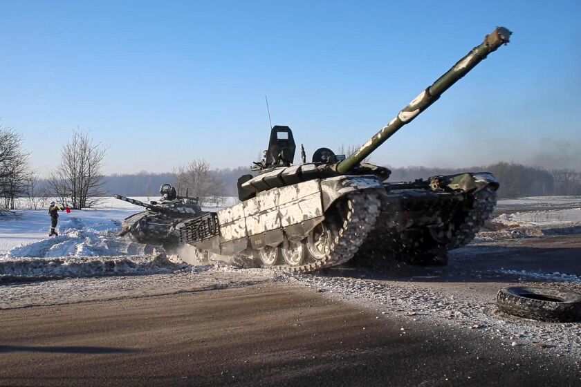 In this photo taken from video provided by the Russian Defense Ministry Press Service on Tuesday, Feb. 15, 2022, Russian army tanks move back to their permanent base after drills in Russia. In what could be another sign that the Kremlin would like to lower the temperature, Russia's Defense Ministry announced Tuesday that some units participating in military exercises would begin returning to their bases. (Russian Defense Ministry Press Service via AP)