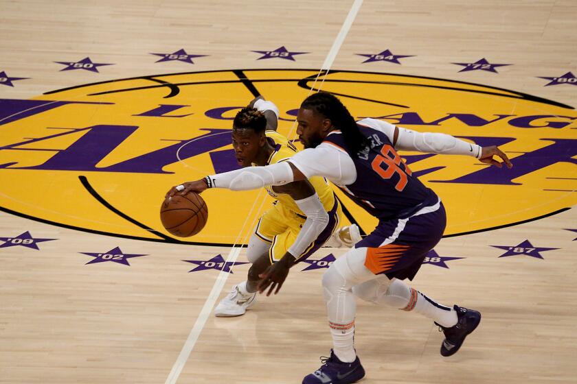 LOS ANGELES, CA - JUNE 03:. Lakers guard Dennis Schroeder and Suns forward Jae Crowder fioght for control of the ball during a 113-100 Suns victory at Staples Center on Thursday, June 3, 2021. The defending champion Lakers have been eliminated from the playoffs. (Luis Sinco / Los Angeles Times)