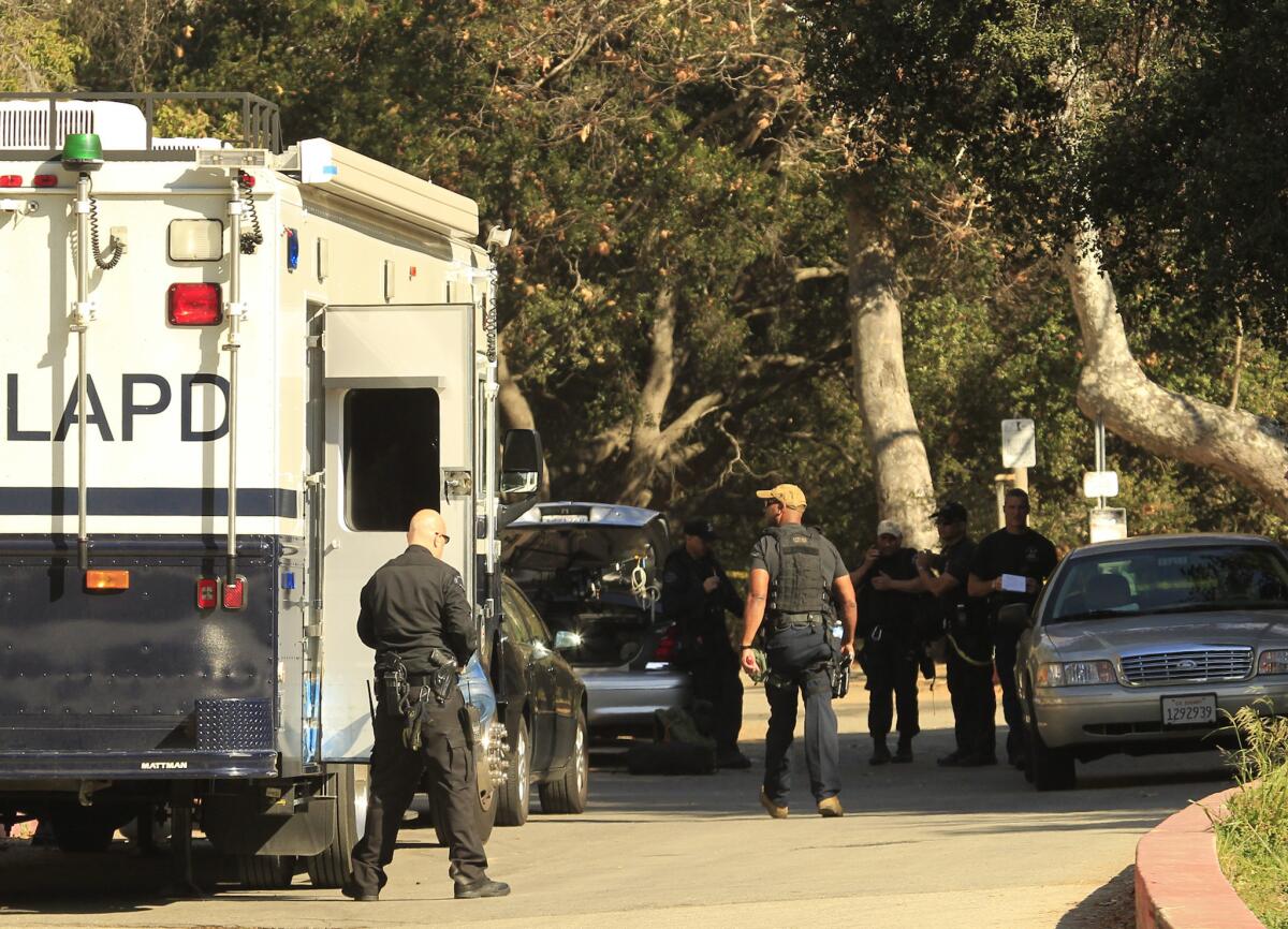 Los Angeles police detectives work a crime scene in Griffith Park off Canyon Drive after a human head was discovered there Jan. 18, 2012.
