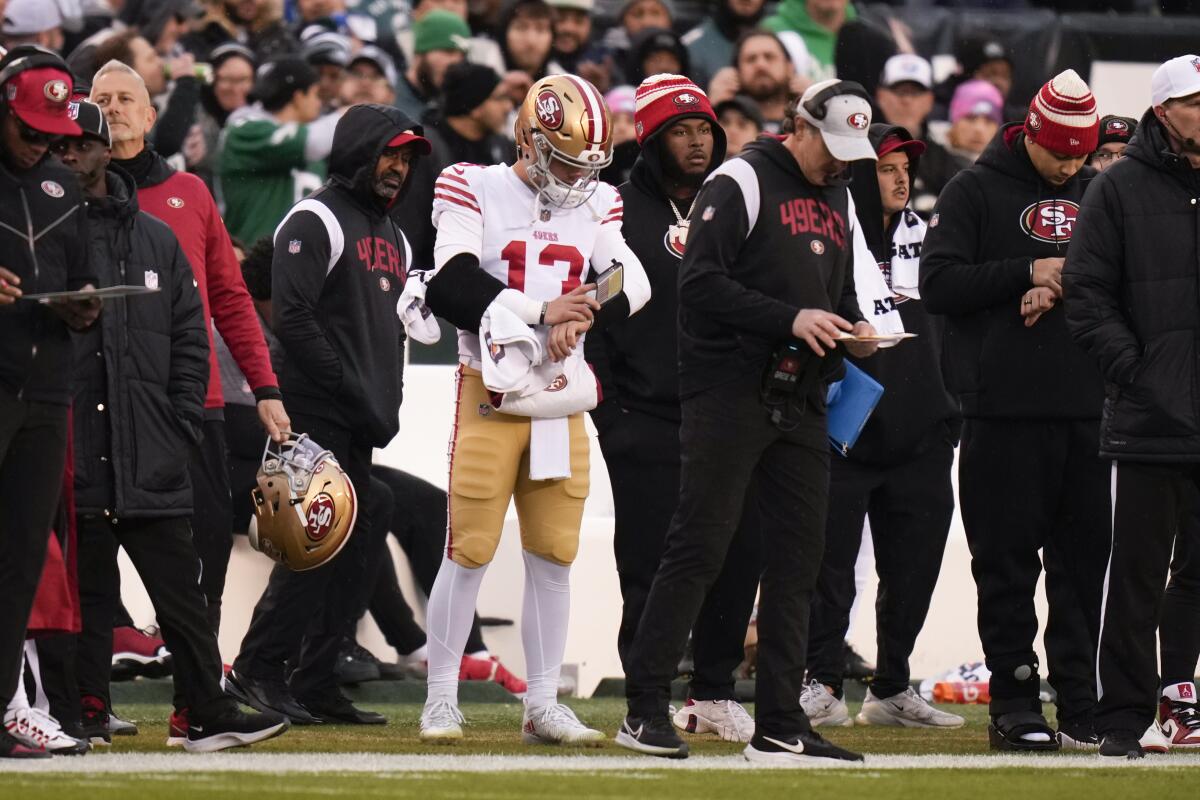 The 49ers' Brock Purdy (13) stands on the sideline after injuring his elbow against the Eagles in the NFC championship game.