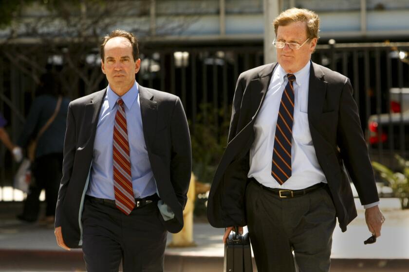 Scott London, left, and attorney Harland W. Braun head for London's first court appearance on insider-trading charges.