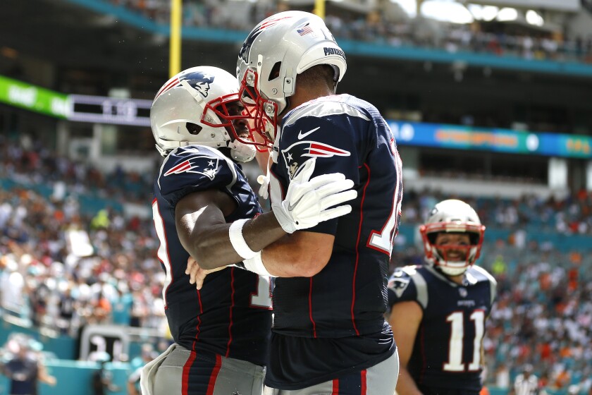 Antonio Brown, left, celebrates with Tom Brady after they connected for a touchdown during Brown's only game with the New England Patriots.