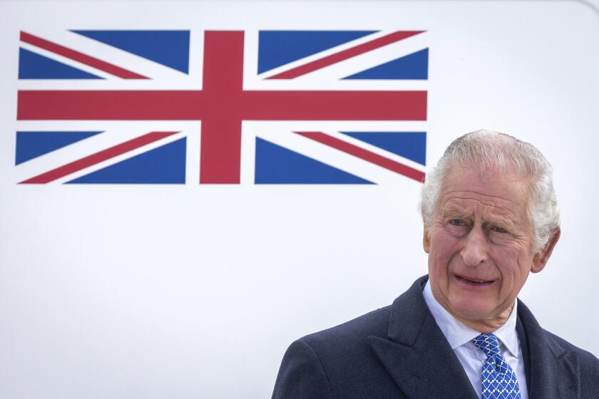 FILE - Britain's King Charles III stands in front of the plane after arriving at Berlin Airport in Berlin, Germany, Wednesday, March 29, 2023. King Charles III for the first time has signaled support for research into the British monarchy’s ties to slavery. A Buckingham Palace spokesperson made the announcement Thursday, April 6 after a document showed an ancestor of his with shares in a slave-trading company. (Britta Pedersen/dpa via AP, File)