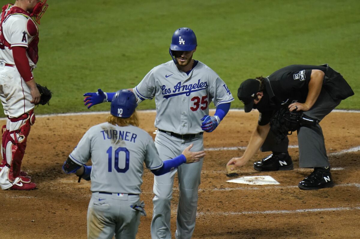 The Dodgers' Cody Bellinger celebrates with teammate Justin Turner after hitting a two-run home run.