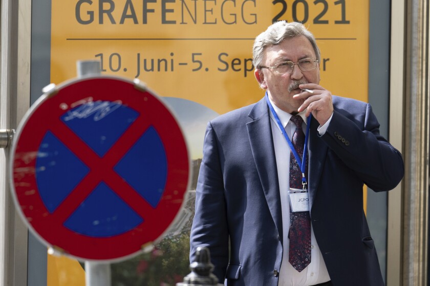 Russia's Governor to the International Atomic Energy Agency (IAEA), Mikhail Ulyanov, smokes a cigarette near the 'Grand Hotel Vienna' where where closed-door nuclear talks take place in Vienna, Austria, Saturday, June 12, 2021. (AP Photo/Florian Schroetter)
