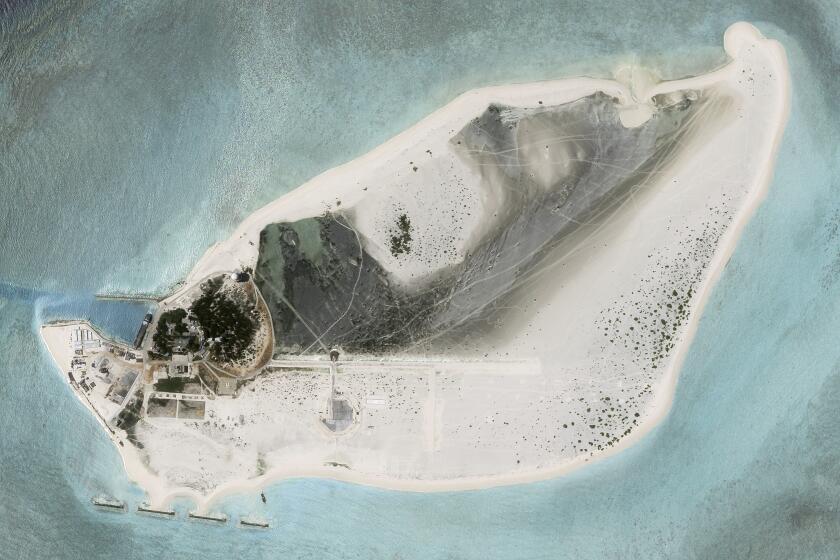 This satellite photo from Planet Labs PBC shows Triton Island in the South China Sea on Tuesday, Aug. 15, 2023. China appears to be constructing an airstrip on a disputed South China Sea island that is also claimed by Vietnam and Taiwan, according to satellite photos analyzed by The Associated Press on Wednesday, Aug. 16, 2023. (Planet Labs PBC via AP)