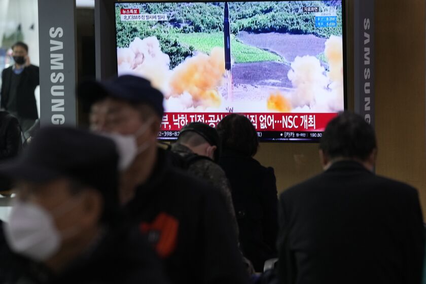 People watch a TV showing a file image of North Korea's missile launch during a news program at the Seoul Railway Station in Seoul, South Korea, Thursday, March 24, 2022. North Korea fired at least one suspected ballistic missile toward the sea Thursday, its neighbors' militaries said, apparently extending its barrage of weapons tests that may culminate with a flight of its biggest-yet intercontinental ballistic missile. (AP Photo/Ahn Young-joon)