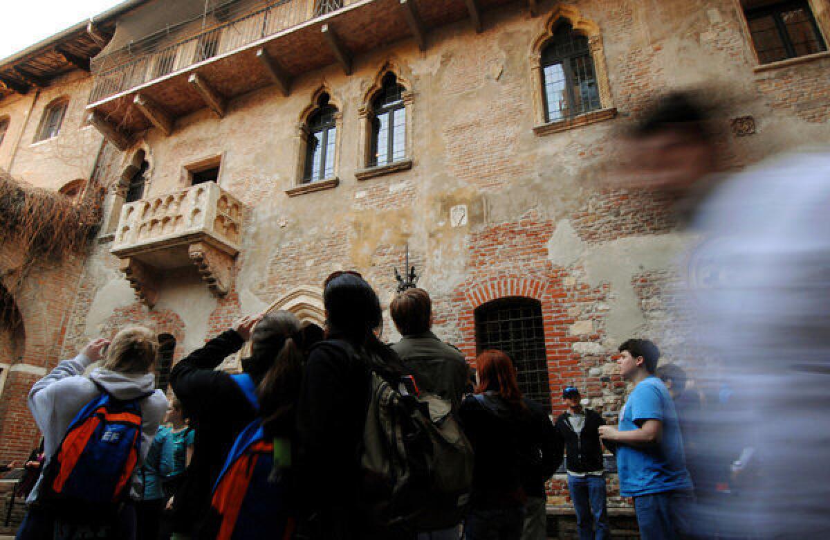 Tourists take pictures of the balcony of a 14th century house that once belonged to the Cappello family, a possible inspiration for the Capulet clan in Shakespeare's "Romeo and Juliet."