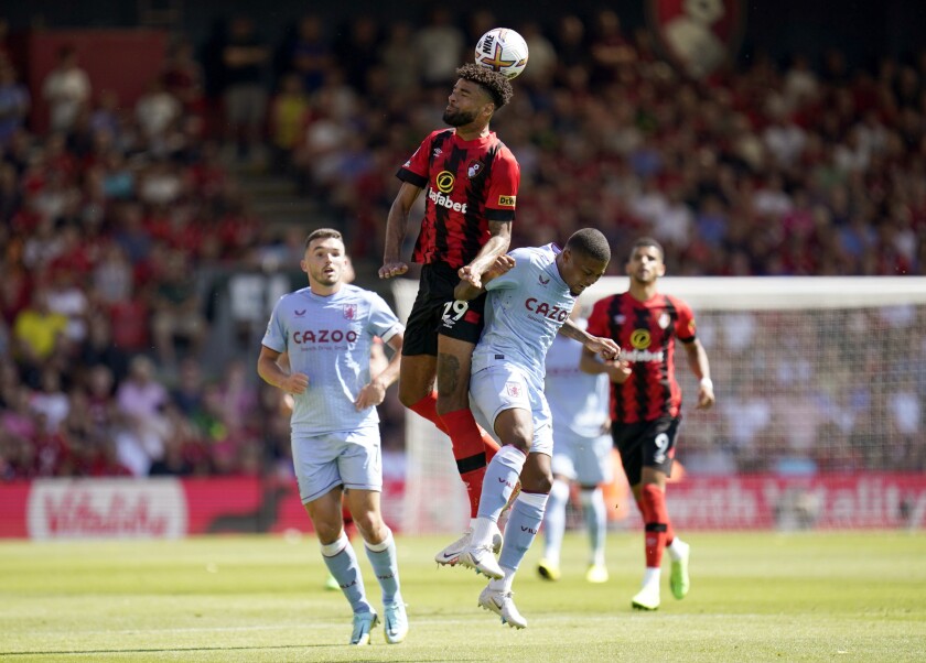 Bournemouth's Philip Billing, centre, and Aston Villa's Leon Bailey battle for the ball, during the English Premier League soccer match between Bournemouth and Aston Villa, at the Vitality Stadium, Bournemouth, England, Saturday, Aug. 6, 2022. (Andrew Matthews/PA via AP)