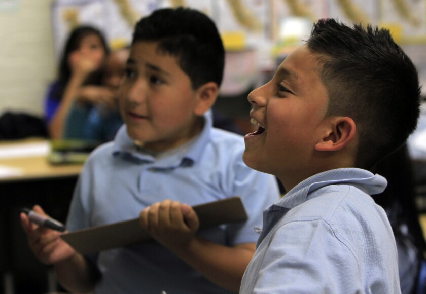 Jason Espinoza, 10, right, enjoying class at Celerity Nascent Charter School in Los Angeles.