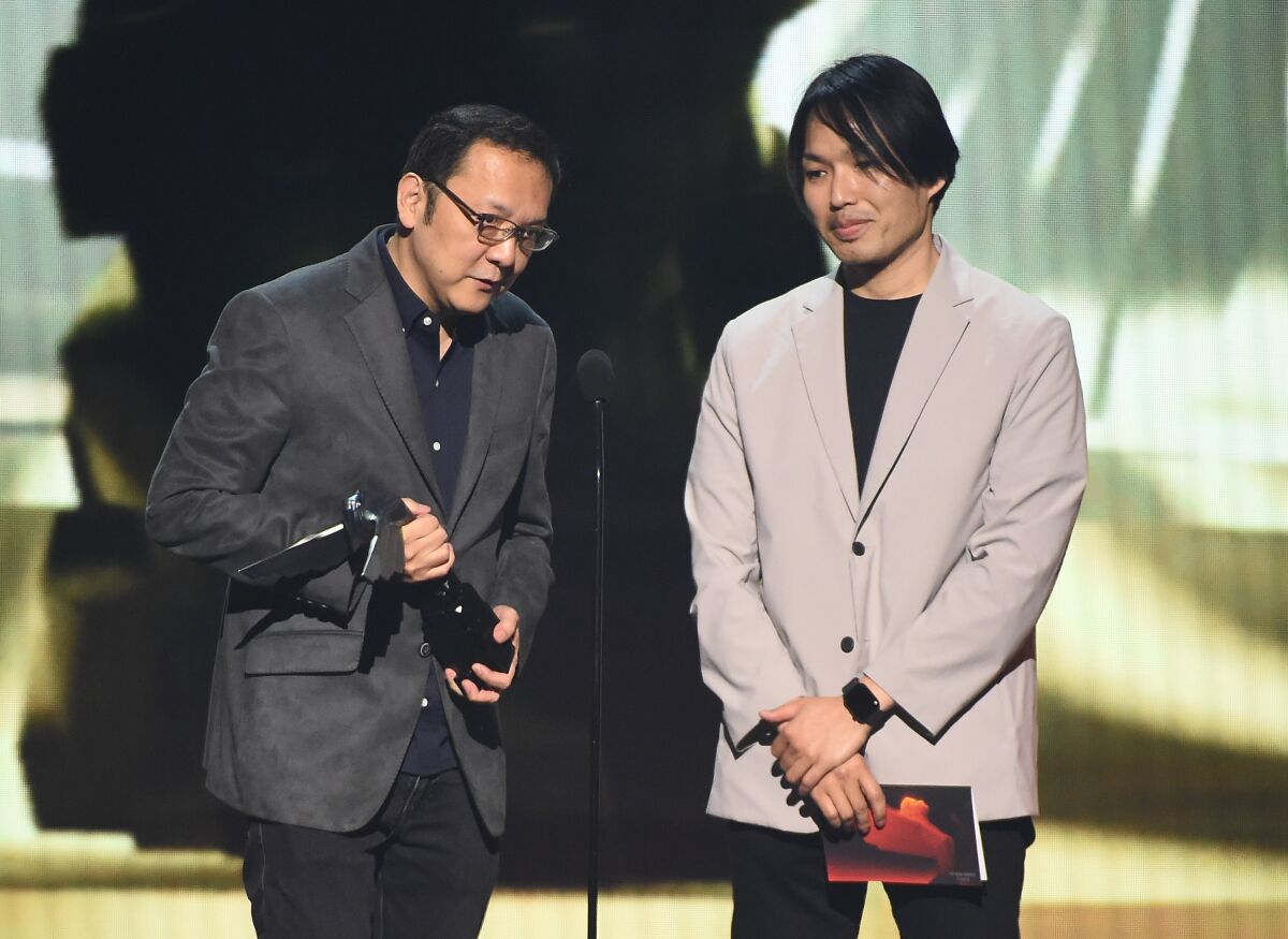 Two men onstage accepting an award