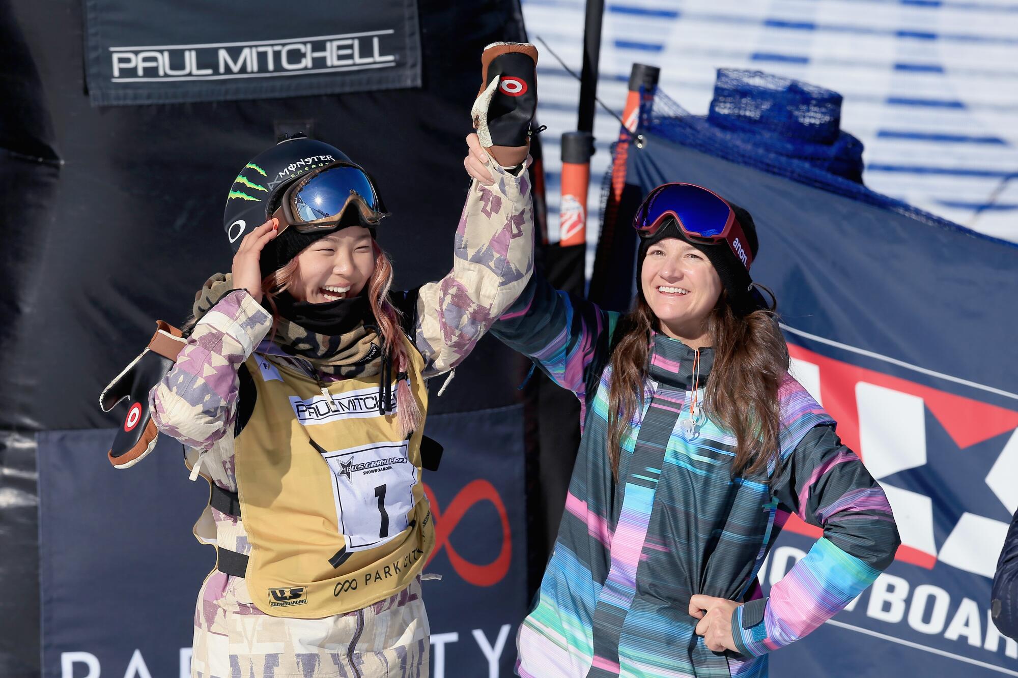 Chloe Kim, left, celebrates a first-place finish with Kelly Clark in the ladies' FIS Snowboard World Cup at the 2016 U.S Snowboarding Park City Grand Prix in Park City, Utah.