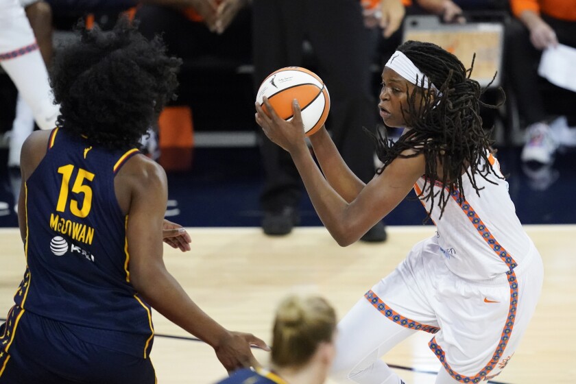 Connecticut Sun's Jonquel Jones (35) goes to the basket against Indiana Fever's Teaira McCowan (15) during the first half of a WNBA basketball game, Saturday, July 3, 2021, in Indianapolis. (AP Photo/Darron Cummings)