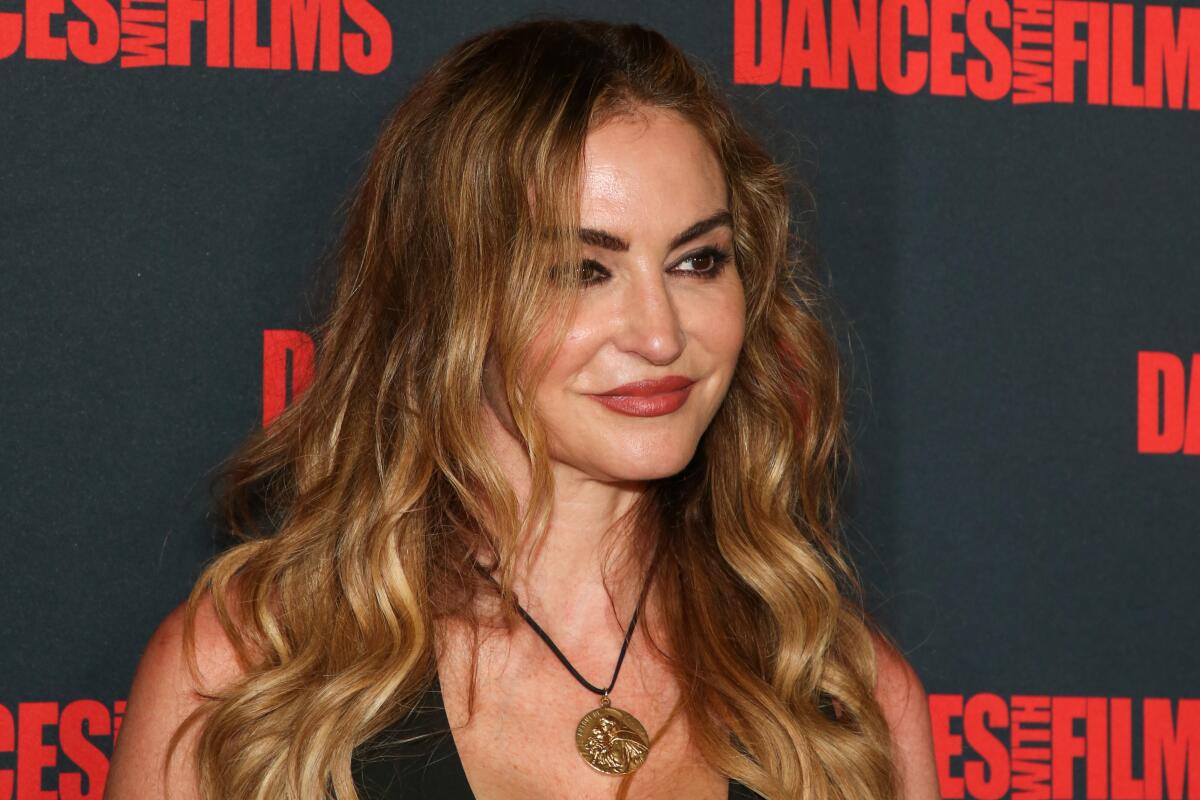 Drea de Matteo smiles with her hair covering her right eye