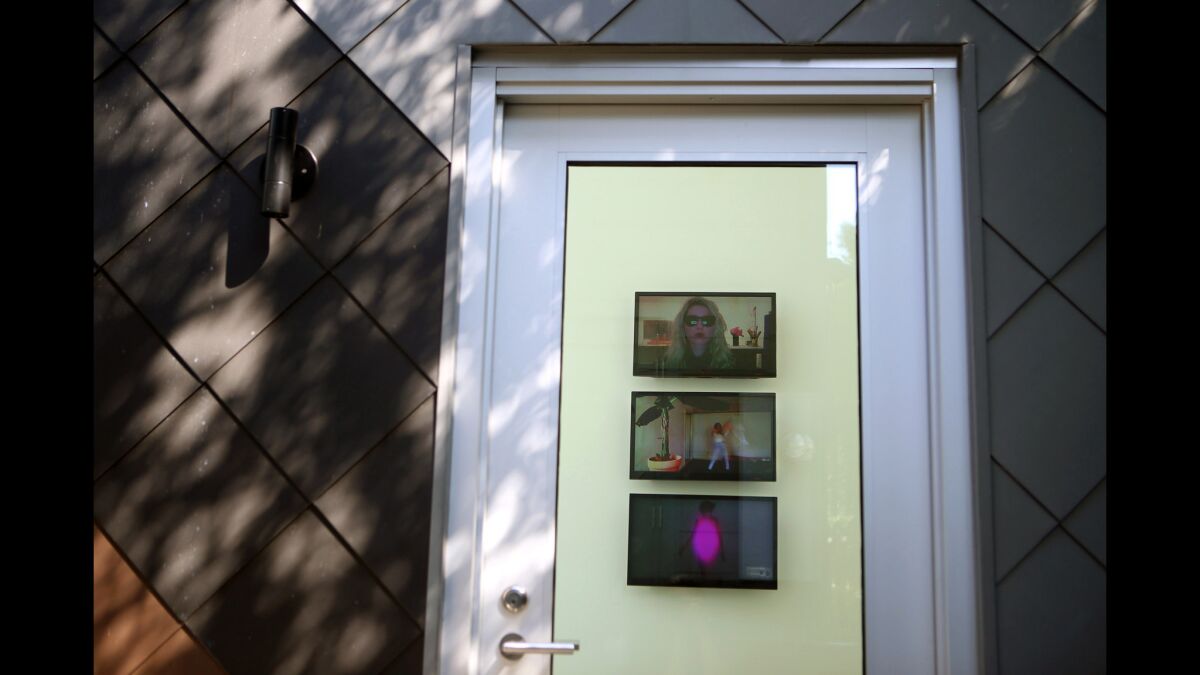 Video art plays on monitors just beyond the main entrance to the private gallery and guest quarters that now stands behind Diane Klein's Craftsman home in Venice.