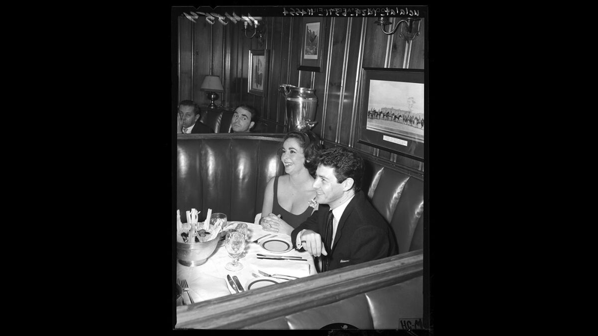 Elizabeth Taylor at Chasen's in 1959 with singer Eddie Fisher, her new husband,