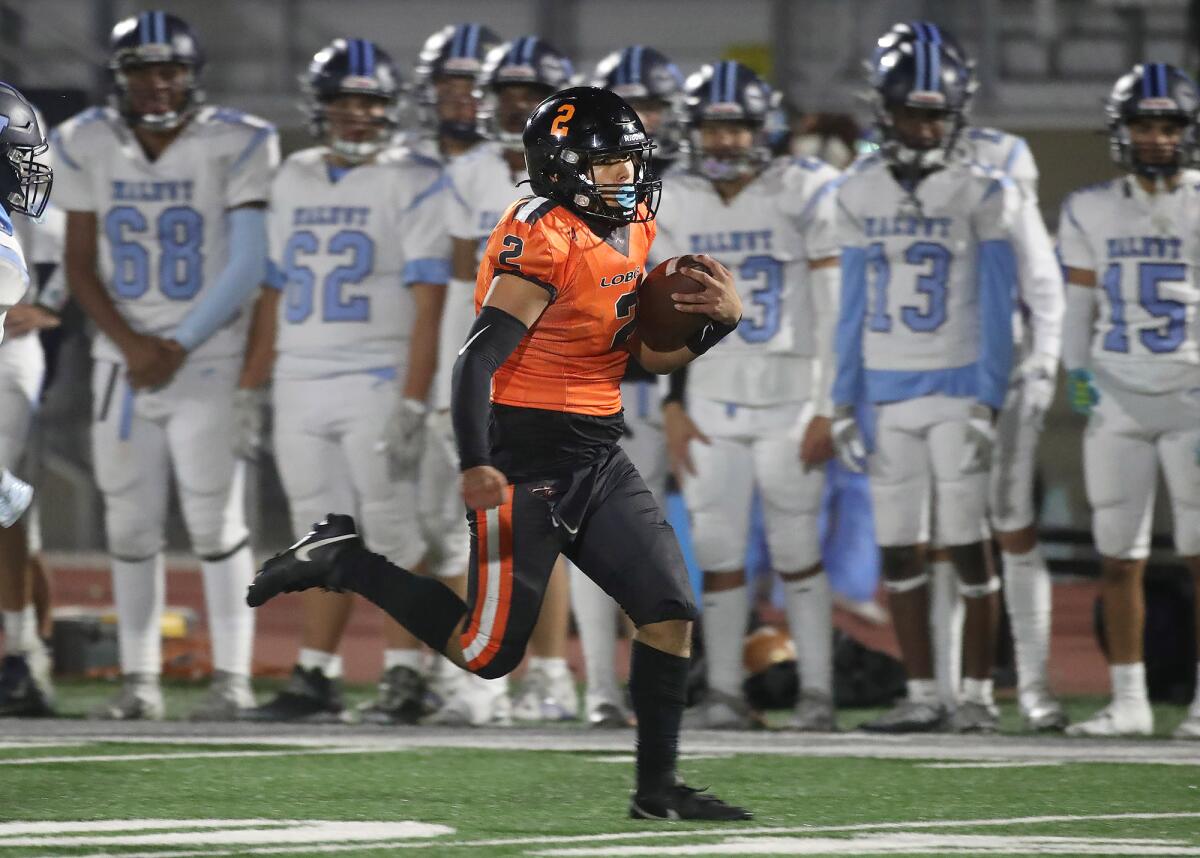 Los Amigos quarterback Maysen Navarro runs down the sideline for a big gain against Walnut on Friday.