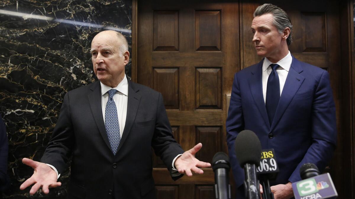 Gov. Jerry Brown, left, responds to a reporter's question following a meeting with Governor-elect Gavin Newsom in Sacramento, Calif. on Nov. 13.