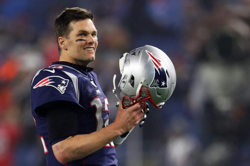 FOXBOROUGH, MASSACHUSETTS - JANUARY 04: Tom Brady #12 of the New England Patriots looks on holding his helmet before the AFC Wild Card Playoff game against the Tennessee Titans at Gillette Stadium on January 04, 2020 in Foxborough, Massachusetts. (Photo by Maddie Meyer/Getty Images)