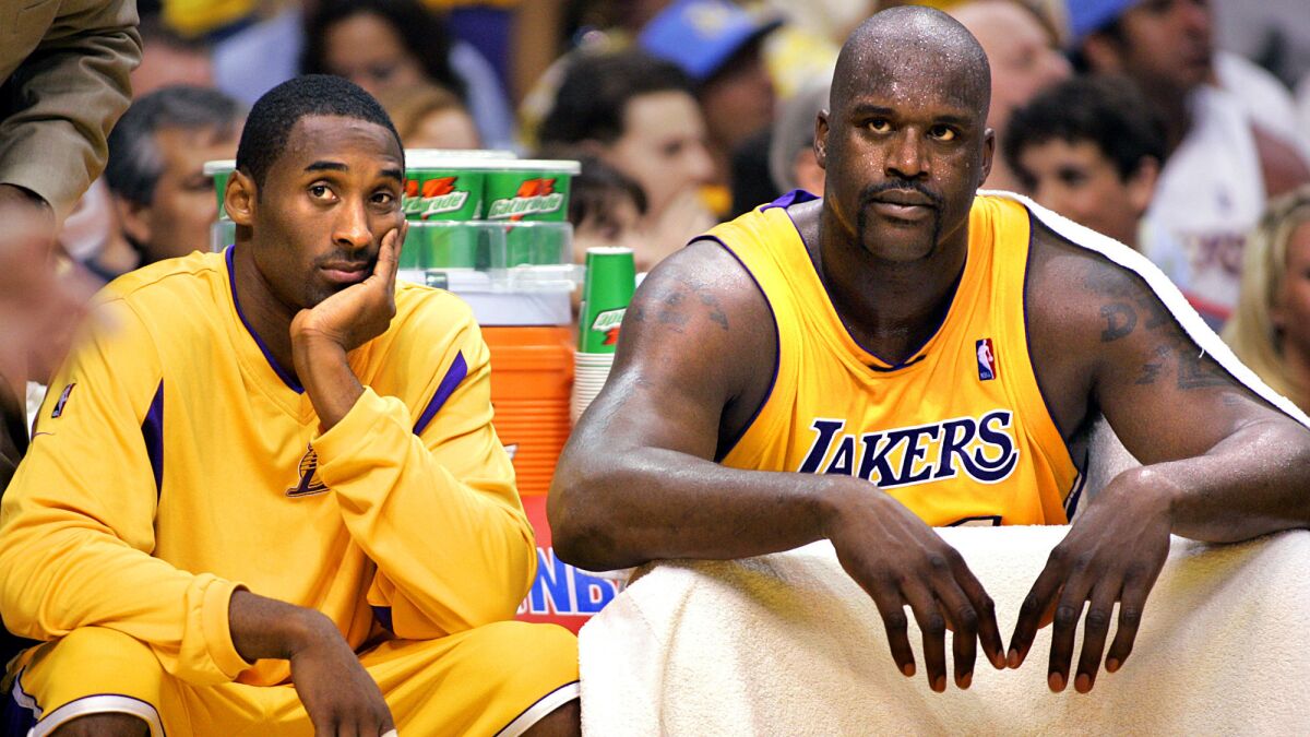 Lakers teammates Kobe Bryant, left, and Shaquille O'Neal sit on the bench during the 2004 Western Conference finals.