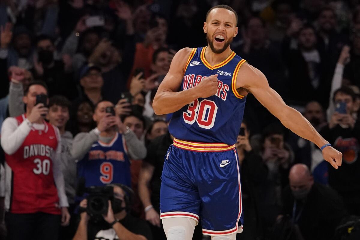 Warriors guard Stephen Curry reacts after making a record-setting three-point shot.