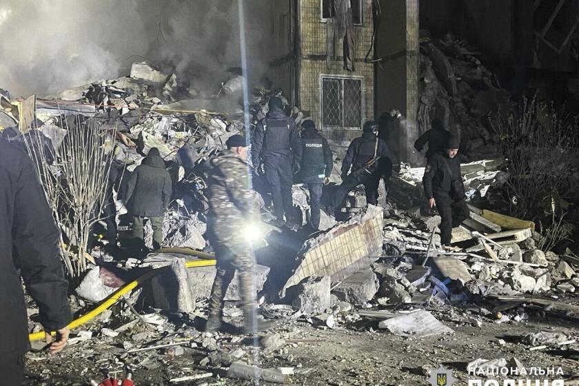In this photo provided by the Ukrainian Police Press Office, emergency workers work on the site of a destroyed multi-store building after a Russian attack on residential neighbourhood in Odesa, Ukraine, Saturday, March 2, 2024. (Ukrainian Police Press Office via AP)