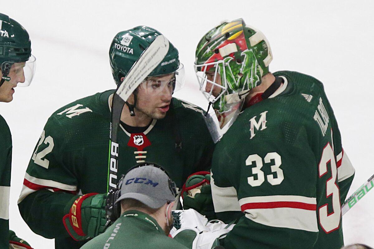 Minnesota Wild goaltender Cam Talbot (33) is congratulated by left wing Kevin Fiala (22) after the team's win over the New York Rangers in an NHL hockey game Tuesday, March 8, 2022, in St. Paul, Minn. (AP Photo/Andy Clayton-King)