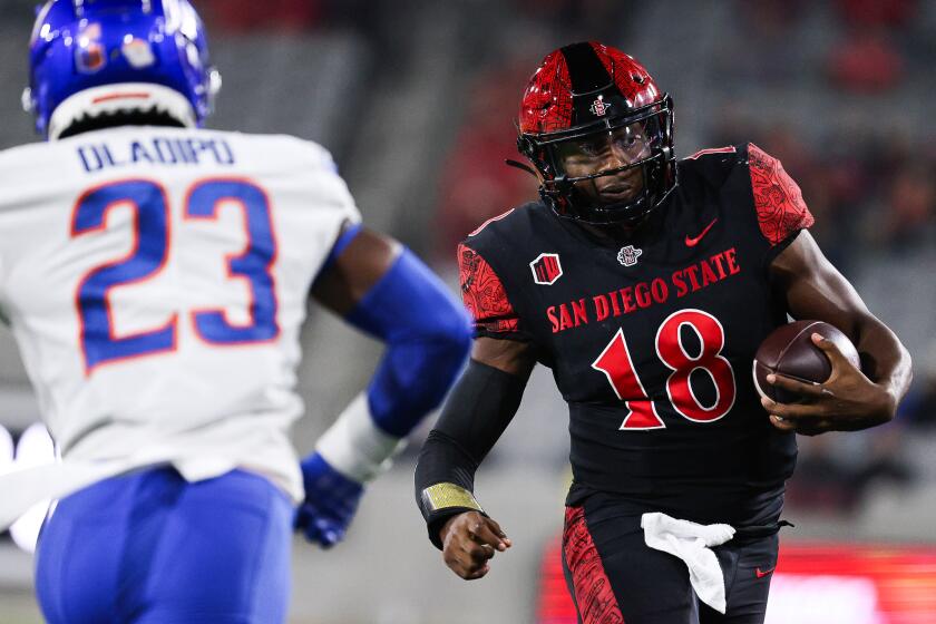 San Diego, CA - September 22: San Diego State quarterback Jalen Mayden (18) runs the ball against Boise State safety Seyi Oladipo (23) during their game at Snapdragon Stadium on Friday, Sept. 22, 2023 in San Diego, CA. (Meg McLaughlin / The San Diego Union-Tribune)