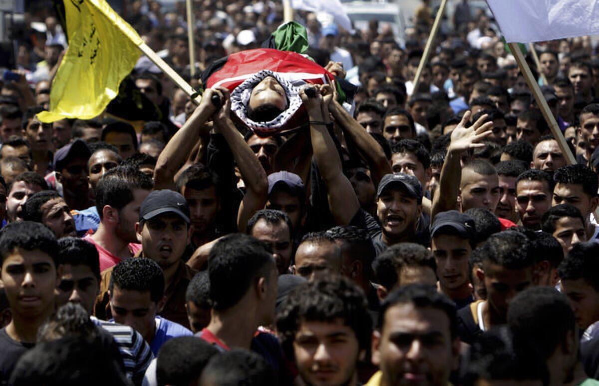 Palestinians carry the body of Majd Lahlouh, 22, during his funeral in the West Bank town of Jenin.
