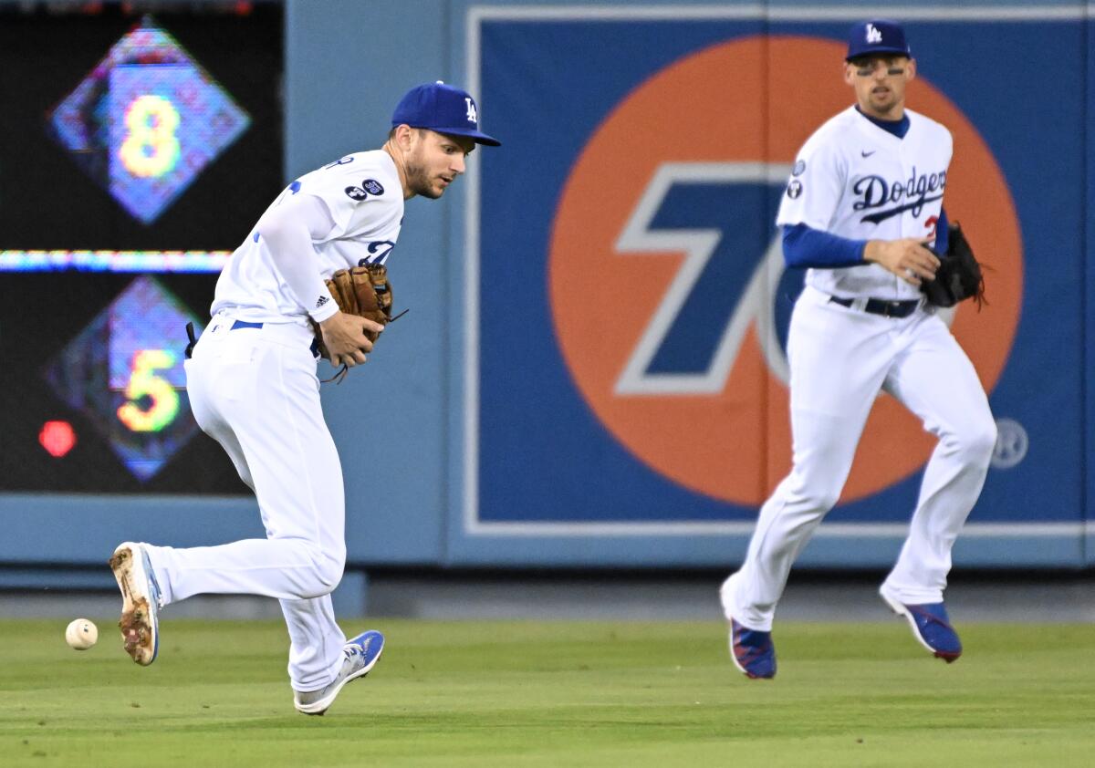 Dodgers shortstop Trea Turner can't make the catch on a single by Colorado Rockies Brendan Rodgers.