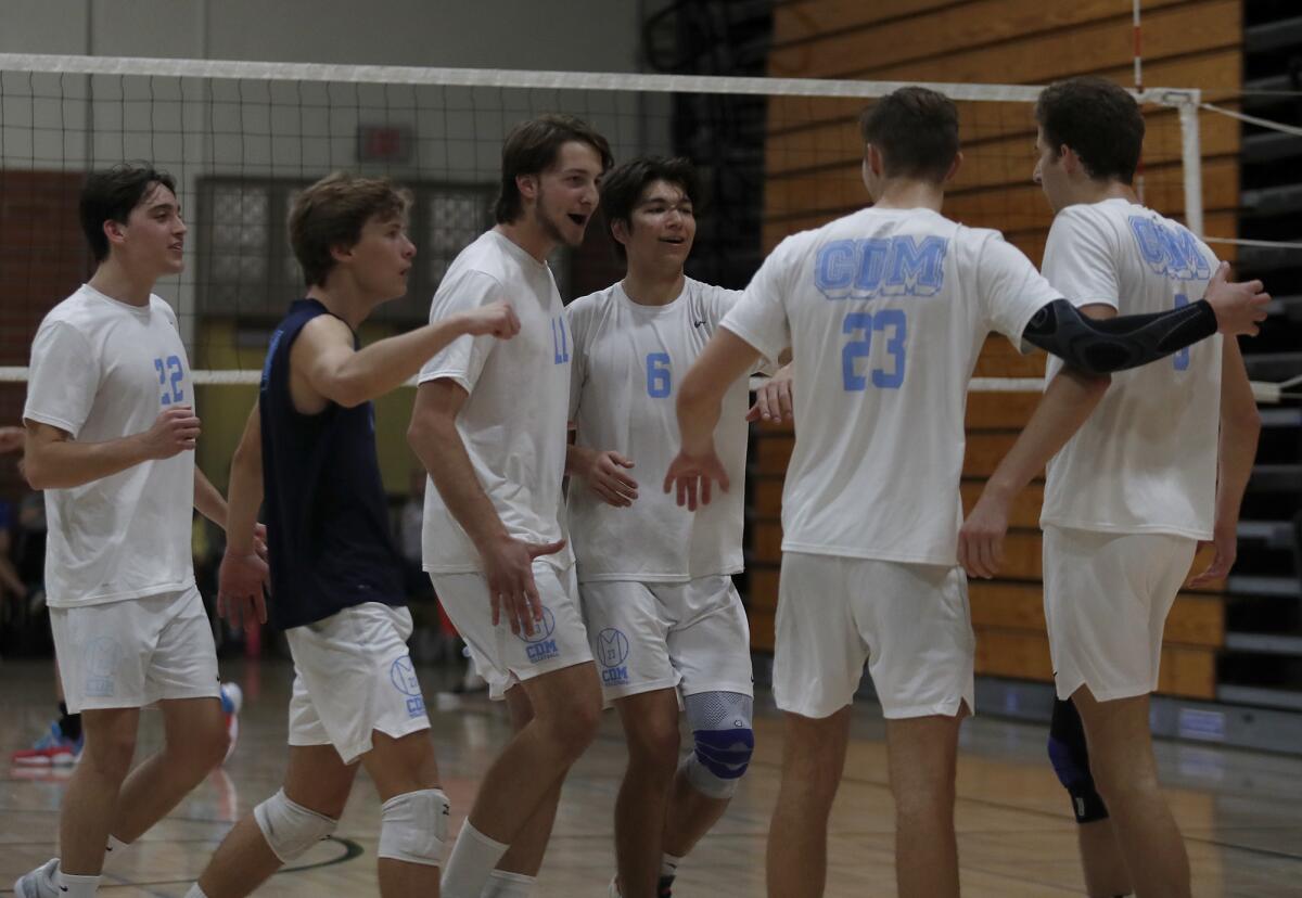Corona del Mar players celebrate a point against Huntington Beach in the second set of an Orange County Championships boys' volleyball tournament semifinal match at Edison High on Saturday.