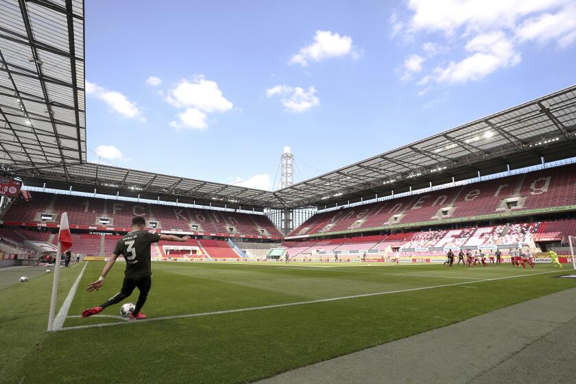 Aaron of FSV Mainz 05 takes a corner kick during the German Bundesliga soccer match between 1. FC Cologne and FSV Mainz 05 in Cologne, Germany, Sunday, May 17, 2020. The German Bundesliga is the world's first major soccer league to resume after a two-month suspension because of the coronavirus pandemic. (AP Photo/Lars Baron, Pool)