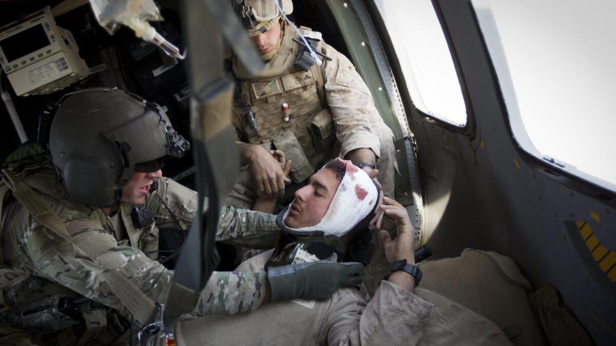 A wounded Marine who suffered a concussion is evacuated from Afghanistan's Helmand province in 2011. A new study of veterans found that traumatic brain injuries, even mild ones, were associated with an increased risk of dementia.