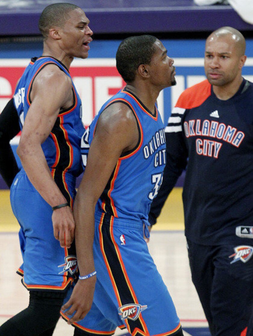 Kevin Durant, center, is congratulated by Russell Westbrook, left, and Derek Fisher after hitting a three-pointer that wound up being the game-winner.