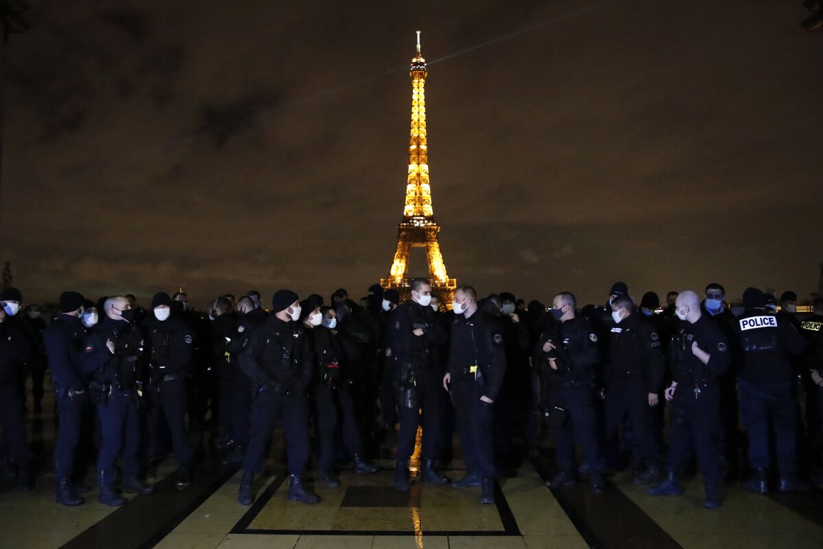 French police officers gather on the Trocadero square in front of the Eiffel Tower to protest against their working conditions, Friday, Dec. 11, 2020 in Paris. Demonstrators in France have protested a proposed bill that could make it more difficult for witnesses to film police officers. Critics fear that the law could impinge on press freedom and make it more difficult to expose police brutality. (AP Photo/Francois Mori)