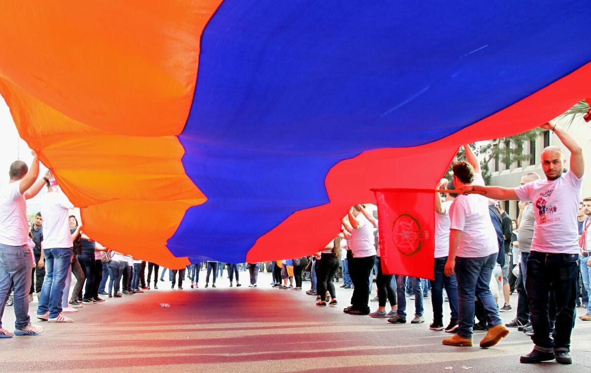 Lebanese Armenians wave a giant flag during a rally outside the Turkish embassy in the capital Beirut on April 23, 2016, to commemorate the 101th anniversary of the mass killings of Armenians under the Ottoman Empire in 1915.