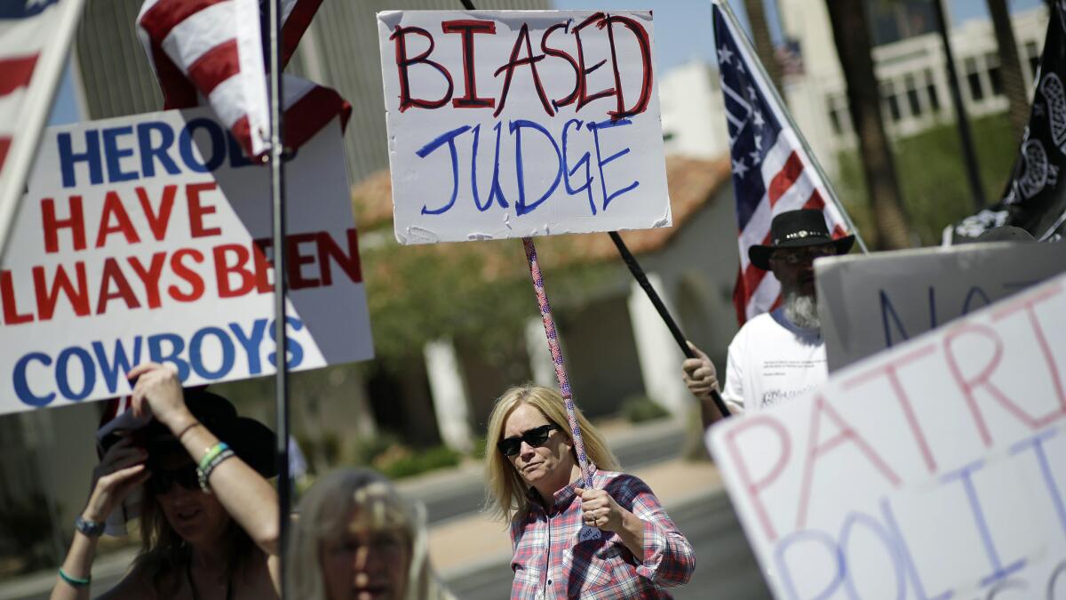 Demonstrators show their support for six men on trial in Las Vegas who are accused of wielding weapons to stop federal agents.