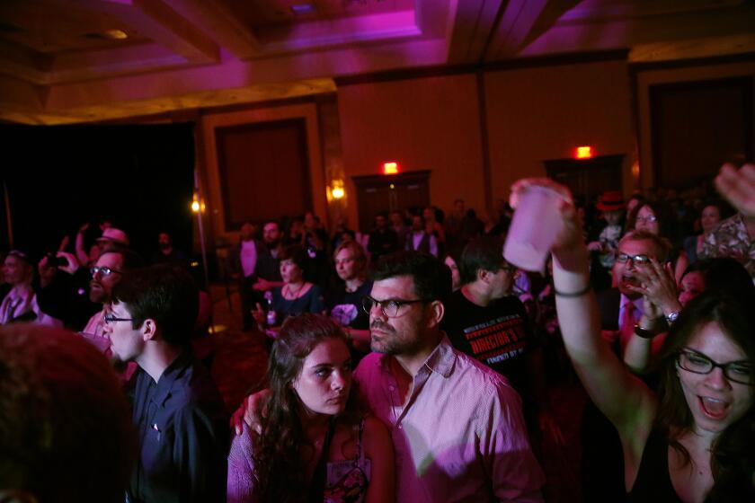 Ryan Bell is caught in an uncomfortable moment with his teenage daughter Zoe as they attend a late-night gathering of atheists hosted by magician Penn Jillette.