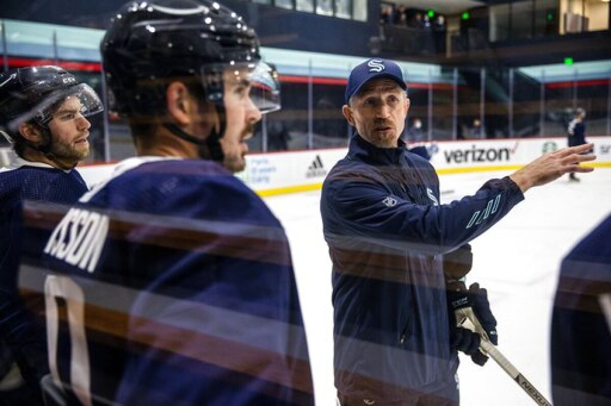 Seattle Kraken head coach Dave Hakstol discuss a drill with players during NHL hockey training camp at Kraken Community Iceplex on Thursday, Sept. 23, 2021, in Seattle. (Amanda Snyder/The Seattle Times via AP)