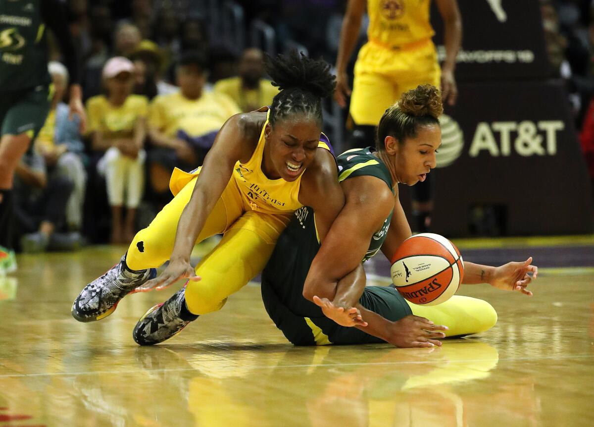 Sparks forward Nneka Ogwumike, left, and Seattle Storm forward Mercedes Russell battle for a loose ball.