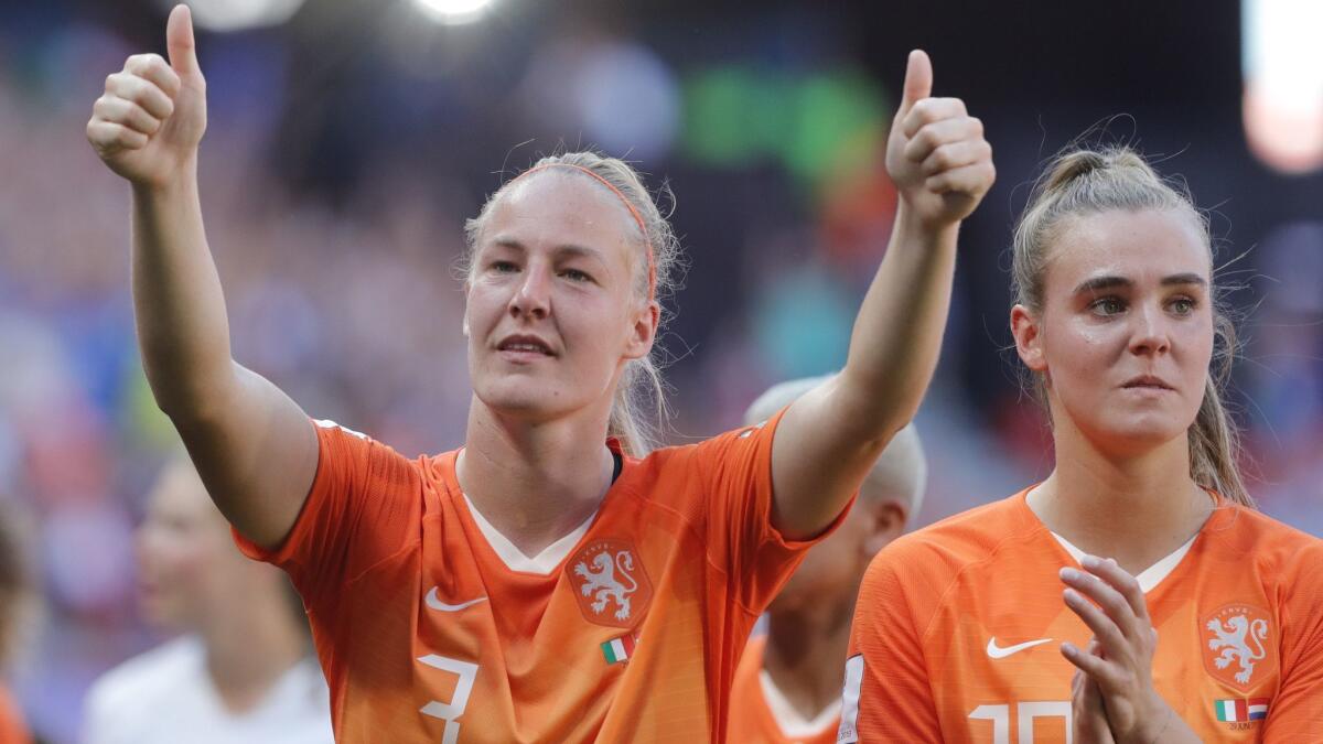 The Netherlands' Stefanie Van Der Gragt, left, and Jill Roord acknowledge Dutch fans after defeating Italy 2-0 in a Women's World Cup quarterfinal on Saturday.